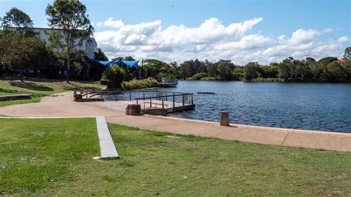 Lake Eden at North Lakes Town Park with boardwalk and open lawn