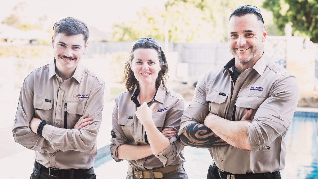 Three Jackfruit team members in branded work shirts