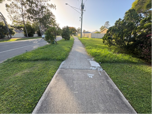 A well-kept lawn and footpath in a Moreton Bay suburb