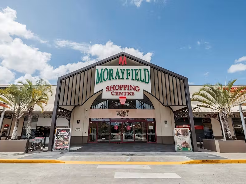 Morayfield Shopping Centre entrance with palm trees on a clear day